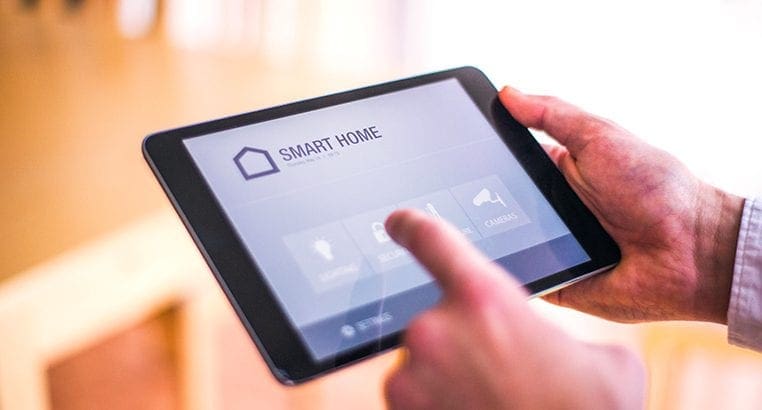 Person interacting with a smart home app on a tablet